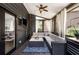Relaxing screened-in porch featuring a comfortable seating area with a ceiling fan and TV at 1701 Clay Brooke Se Ct, Smyrna, GA 30082