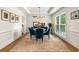 Dining room with coffered ceilings, wainscoting, and a round wood table with teal upholstered chairs at 1701 Clay Brooke Se Ct, Smyrna, GA 30082