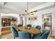Bright dining room featuring stylish lighting, and an elegant oval table with seating for six at 1701 Clay Brooke Se Ct, Smyrna, GA 30082
