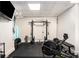 Well-equipped home gym with weightlifting equipment, rubber flooring, and TV for workout entertainment at 1701 Clay Brooke Se Ct, Smyrna, GA 30082