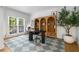 Bright home office with a large window, custom bookshelves, and an area rug at 1701 Clay Brooke Se Ct, Smyrna, GA 30082