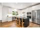 Well-lit kitchen featuring stainless steel appliances, a center island with seating, and white cabinetry at 1701 Clay Brooke Se Ct, Smyrna, GA 30082