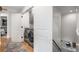 Convenient laundry room with stainless steel washer and dryer on hardwood flooring, and access to the staircase at 1701 Clay Brooke Se Ct, Smyrna, GA 30082
