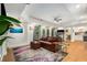 Spacious living area featuring a leather sofa, vibrant rug, hardwood floors and walkout doors to the back yard at 1701 Clay Brooke Se Ct, Smyrna, GA 30082