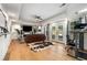 Expansive living area with hardwood floors, ceiling fan, leather sofa and walkout doors to a backyard patio at 1701 Clay Brooke Se Ct, Smyrna, GA 30082