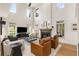 Bright living room with a high ceiling, fireplace, and large windows, offering ample natural light at 1701 Clay Brooke Se Ct, Smyrna, GA 30082