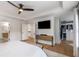 Open main bedroom showcasing hard floors, modern media cabinet, and spacious walk-in closet at 1701 Clay Brooke Se Ct, Smyrna, GA 30082