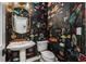 Whimsical powder room featuring unique wallpaper, pedestal sink, and elegant gold finishes at 1701 Clay Brooke Se Ct, Smyrna, GA 30082