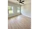 This bedroom features two windows providing ample light and a ceiling fan for comfort at 3106 Zodiac Ct, Lawrenceville, GA 30044
