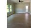 Bright living room features wood-look flooring, a ceiling fan, and a glass paneled door to the backyard at 3106 Zodiac Ct, Lawrenceville, GA 30044