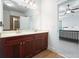 Bathroom features a double vanity with dark wood cabinets, a large mirror, and tile floors, offering space and style at 3202 Saute Way, Avondale Estates, GA 30002