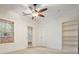 Bright bedroom with a ceiling fan, natural light, a door to the outside, and a built in bookshelf at 3202 Saute Way, Avondale Estates, GA 30002