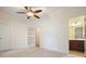 Spacious bedroom with a ceiling fan, adjoining bathroom, and a built in bookshelf at 3202 Saute Way, Avondale Estates, GA 30002