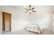 Neutral-toned bedroom with carpet, a ceiling fan, and an adjoining room at 3202 Saute Way, Avondale Estates, GA 30002