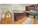 Open-concept kitchen features stainless steel appliances, granite counters, and hardwood flooring at 3202 Saute Way, Avondale Estates, GA 30002