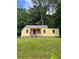 Charming yellow bungalow with a lovely front yard and a welcoming porch area at 451 Collier Ridge Nw Dr, Atlanta, GA 30318
