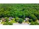 Aerial view of a neighborhood with lush green landscaping and mature trees surrounding well-maintained homes at 733 Exchange Mill Pl, Dacula, GA 30019