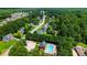 Aerial view of neighborhood pool, surrounded by trees and houses at 733 Exchange Mill Pl, Dacula, GA 30019