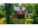 The home's backyard features a deck, stairs, mature trees, and a lush green lawn at 733 Exchange Mill Pl, Dacula, GA 30019