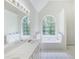 Bright bathroom featuring dual sinks, white cabinetry, tiled floors, and a bright window at 733 Exchange Mill Pl, Dacula, GA 30019