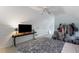 Bedroom featuring a bed, ceiling fan, and an adjacent desk with a flat screen TV at 733 Exchange Mill Pl, Dacula, GA 30019