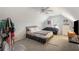 Bedroom featuring a gray bed, small black couch, wainscotting, and a ceiling fan at 733 Exchange Mill Pl, Dacula, GA 30019
