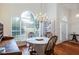 Cozy dining area featuring hardwood floors, a chandelier, and a large window at 733 Exchange Mill Pl, Dacula, GA 30019