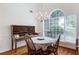 Bright dining room with hardwood floors, chandelier, and large window at 733 Exchange Mill Pl, Dacula, GA 30019