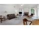 Spacious living area featuring a fireplace, leather sofa, and hardwood accents at 733 Exchange Mill Pl, Dacula, GA 30019