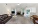 Cozy living room featuring a brick fireplace, vaulted ceiling, and plush seating at 733 Exchange Mill Pl, Dacula, GA 30019