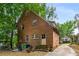 Exterior view of the brick home featuring a well-maintained garden, stairs, and nearby street access at 1200 Mansfield Ne Ave, Atlanta, GA 30307