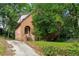 Exterior view of the charming brick home featuring a private entrance and a concrete driveway at 1200 Mansfield Ne Ave, Atlanta, GA 30307