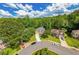 Scenic aerial view of a home in a lush, green neighborhood with mature trees and well-maintained lawns at 1625 Hawkins Cove Trl, Roswell, GA 30076