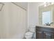 Functional bathroom featuring a toilet, sink, and walk-in shower with a curtain at 1625 Hawkins Cove Trl, Roswell, GA 30076