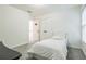 Neutrally decorated bedroom with a twin bed, closet, and bright window at 1625 Hawkins Cove Trl, Roswell, GA 30076