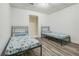 Simple bedroom featuring two twin beds with laminate wood flooring at 1625 Hawkins Cove Trl, Roswell, GA 30076