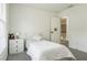 Bright bedroom featuring a white single bed, neutral walls, and a nearby doorway at 1625 Hawkins Cove Trl, Roswell, GA 30076