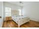 Bright bedroom featuring hardwood floors, and large windows overlooking the yard at 1625 Hawkins Cove Trl, Roswell, GA 30076