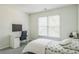 Well-lit bedroom with desk, bed, window, and carpeted floors at 1625 Hawkins Cove Trl, Roswell, GA 30076