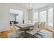 Sunlit dining room featuring a modern chandelier, and large windows overlooking the yard at 1625 Hawkins Cove Trl, Roswell, GA 30076