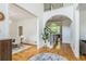 Elegant foyer showcasing hardwood floors, staircase, dining room, and living room with an archway at 1625 Hawkins Cove Trl, Roswell, GA 30076