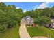 Elegant two-story home with a well-manicured lawn, mature trees, and a two-car garage at 1625 Hawkins Cove Trl, Roswell, GA 30076