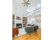Bright living room with a fireplace, hardwood floors, and a view to the second story at 1625 Hawkins Cove Trl, Roswell, GA 30076