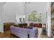 Spacious living room with high ceilings, large windows, hardwood floors, and contemporary furnishings at 1625 Hawkins Cove Trl, Roswell, GA 30076