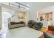Open-concept living room with a staircase, hardwood floors, and a view into the kitchen at 1625 Hawkins Cove Trl, Roswell, GA 30076