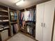 Walk-in closet with custom shelves and wardrobe system for storage at 1625 Hawkins Cove Trl, Roswell, GA 30076