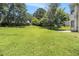 A sprawling backyard boasts a well-maintained lawn and mature trees at 6595 Browns Mill Ferry Dr, Lithonia, GA 30038