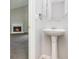 Clean bathroom featuring pedestal sink and fireplace view at 6595 Browns Mill Ferry Dr, Lithonia, GA 30038