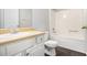 Clean bathroom with white vanity and bathtub with shower at 6595 Browns Mill Ferry Dr, Lithonia, GA 30038