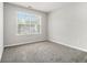 An inviting bedroom showcases neutral walls and cozy gray carpeting at 6595 Browns Mill Ferry Dr, Lithonia, GA 30038